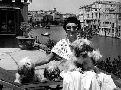 Peggy Guggenheim with her dogs on the roof of her Venetian palazzo by David Seymour, 1950