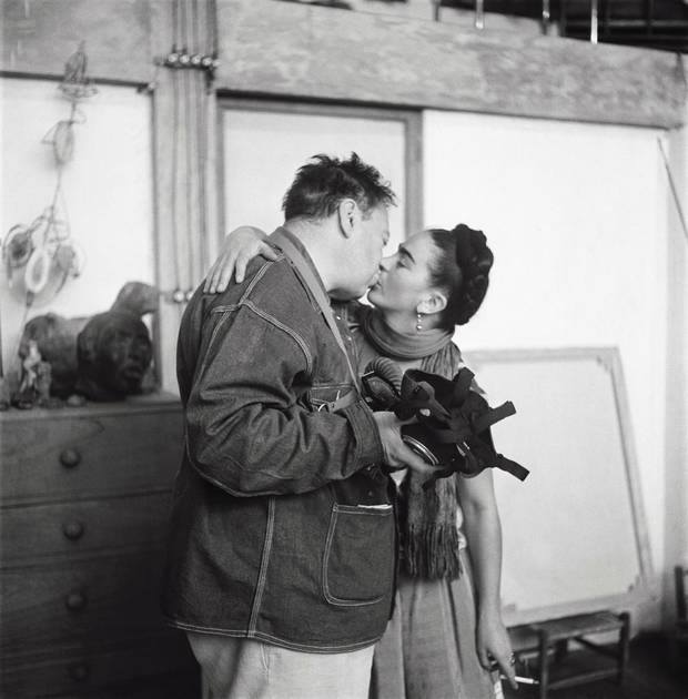 Frida Kahlo and Diego Rivera (with gas mask) kissing, Coyoácan, 1938