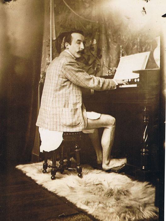 Paul Gauguin playing Mucha's harmonium in his studio - Rue de la Grande Chaumière, Paris c.1893-1994