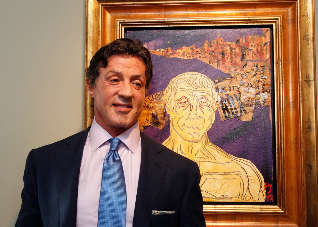 epa02587900 US Actor Sylvester Stallone in front of one of his artworks poses during a press conference ahead of an exhibition, entitled Sylvester Stallone. 35 Years of Painting, at the Gmurzynska gallery in St. Moritz, Switzerland, 17 February 2011. The retrospective which shows 30 pieces painted by Stallone opens to the public from 18 February to 15 March. EPA/ARNO BALZARINI