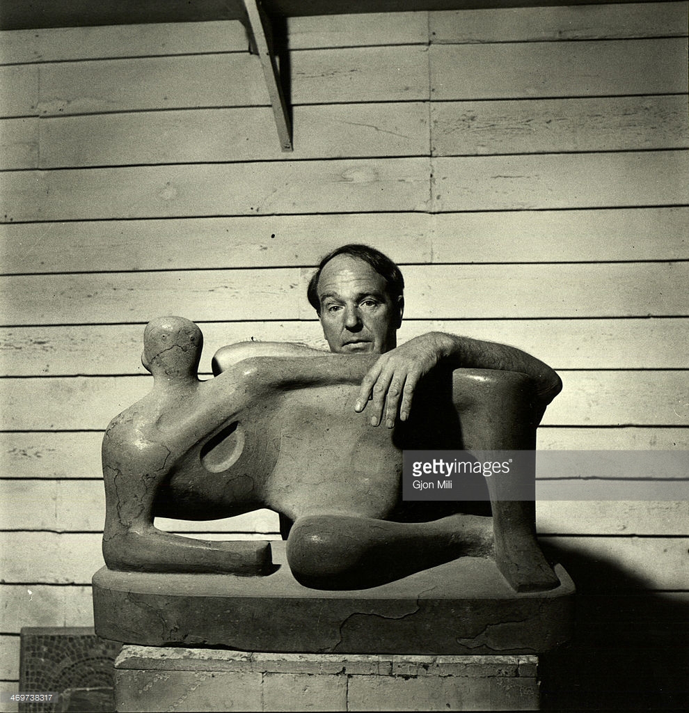 Henry Moore (1898 - 1986) as he poses with one of his works, England, 1949