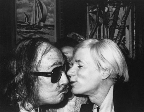 Salvador Dali wearing Christian Dior sunglasses whilst greeting Andy Warhol in Studio 54