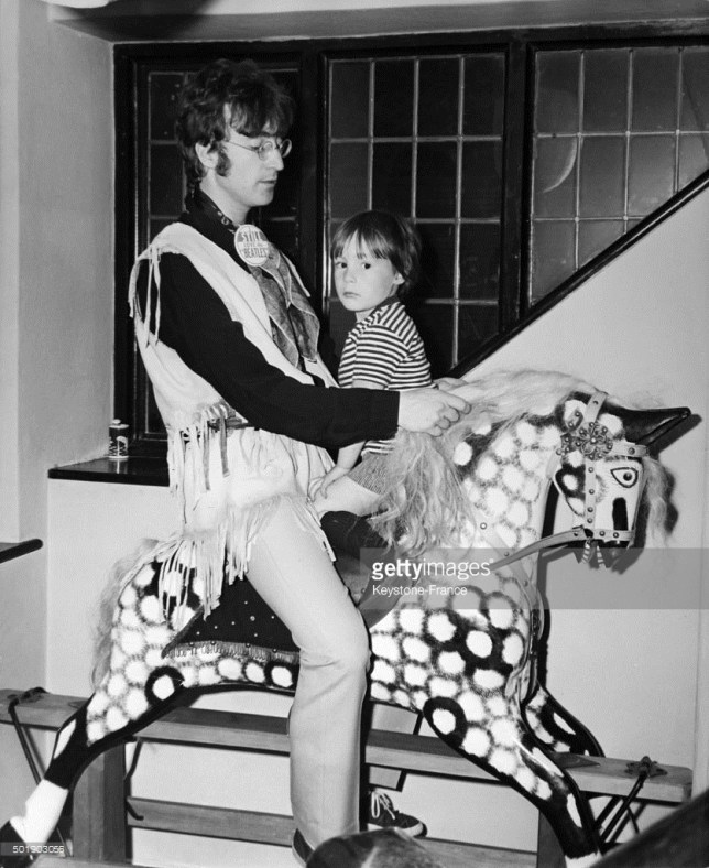 John Lennon and son Julian go for a ride on young Julian's giant rocking horse, in the United Kingdom, ca. 1960