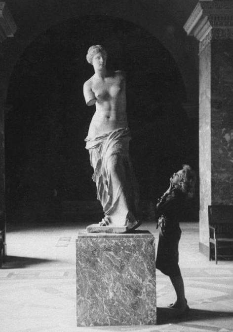 Visitor with Venus de Milo at Musée du Louvre, Paris in 1960s